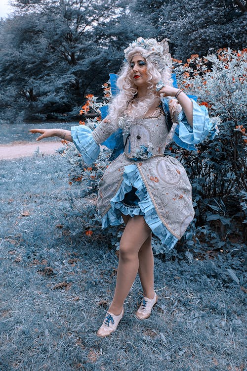 A Woman in Fairytale Costume Standing on the Grass