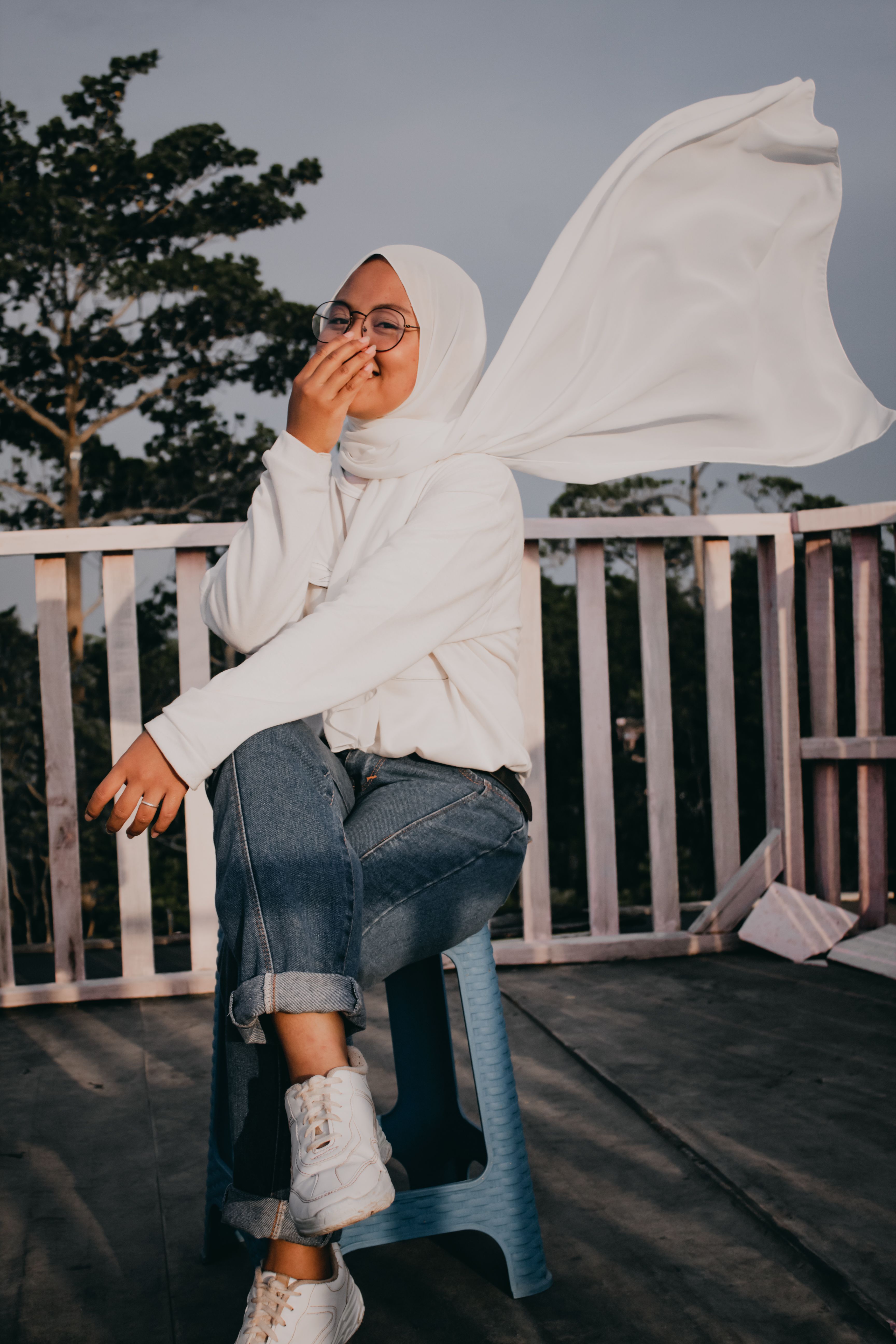 A Woman in White Hijab Sitting on the Chair while Laughing · Free Stock ...