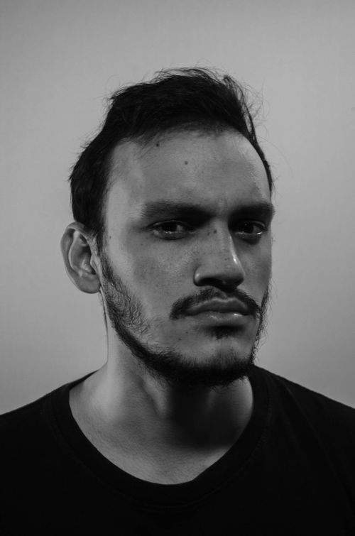 Free Black and white portrait of a young bearded man with intense expression. Stock Photo