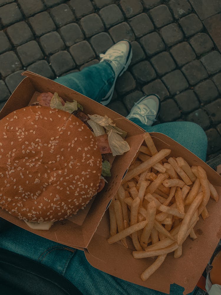 A Burger With Fries On A Brown Box