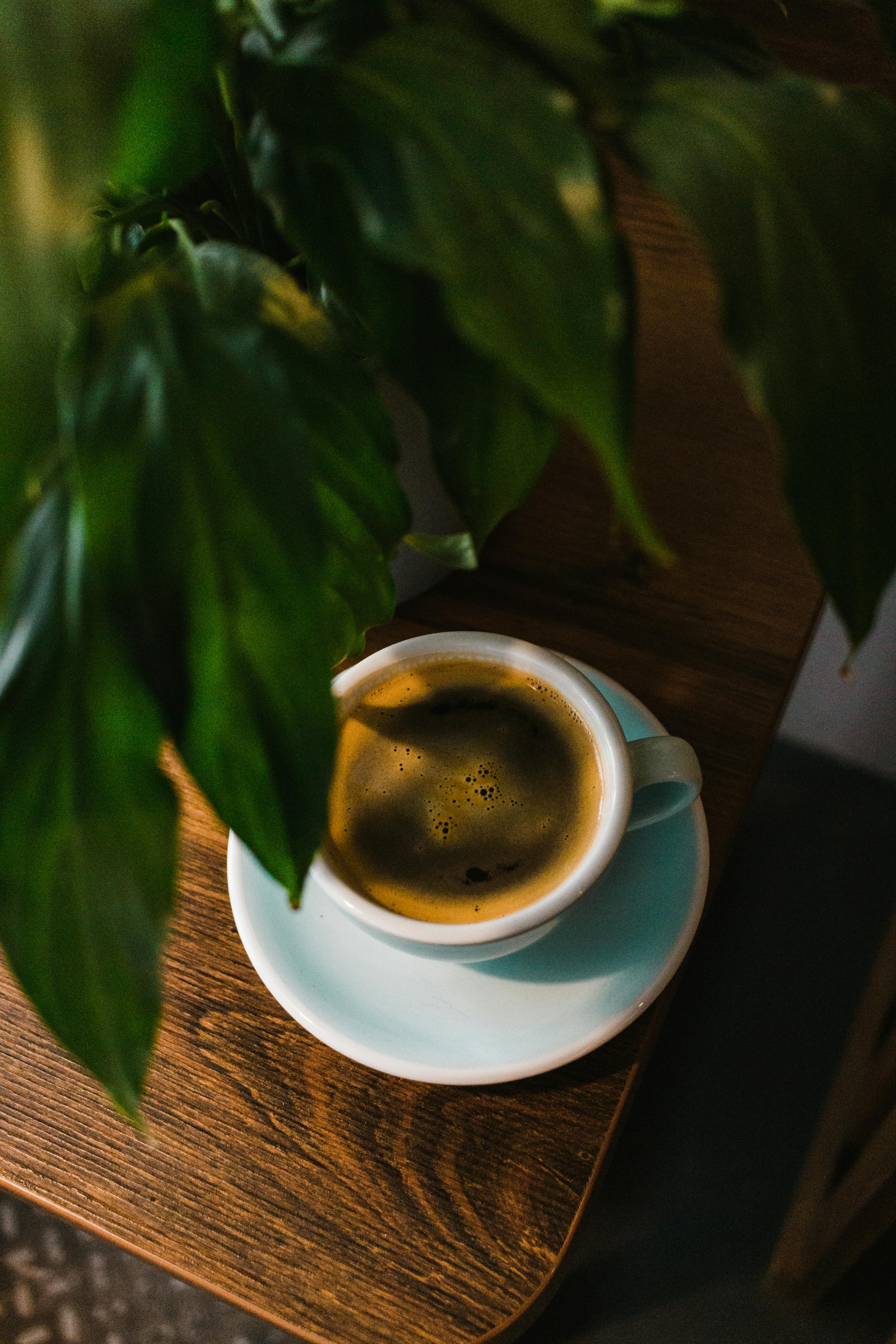 cup of fragrant coffee on wooden table