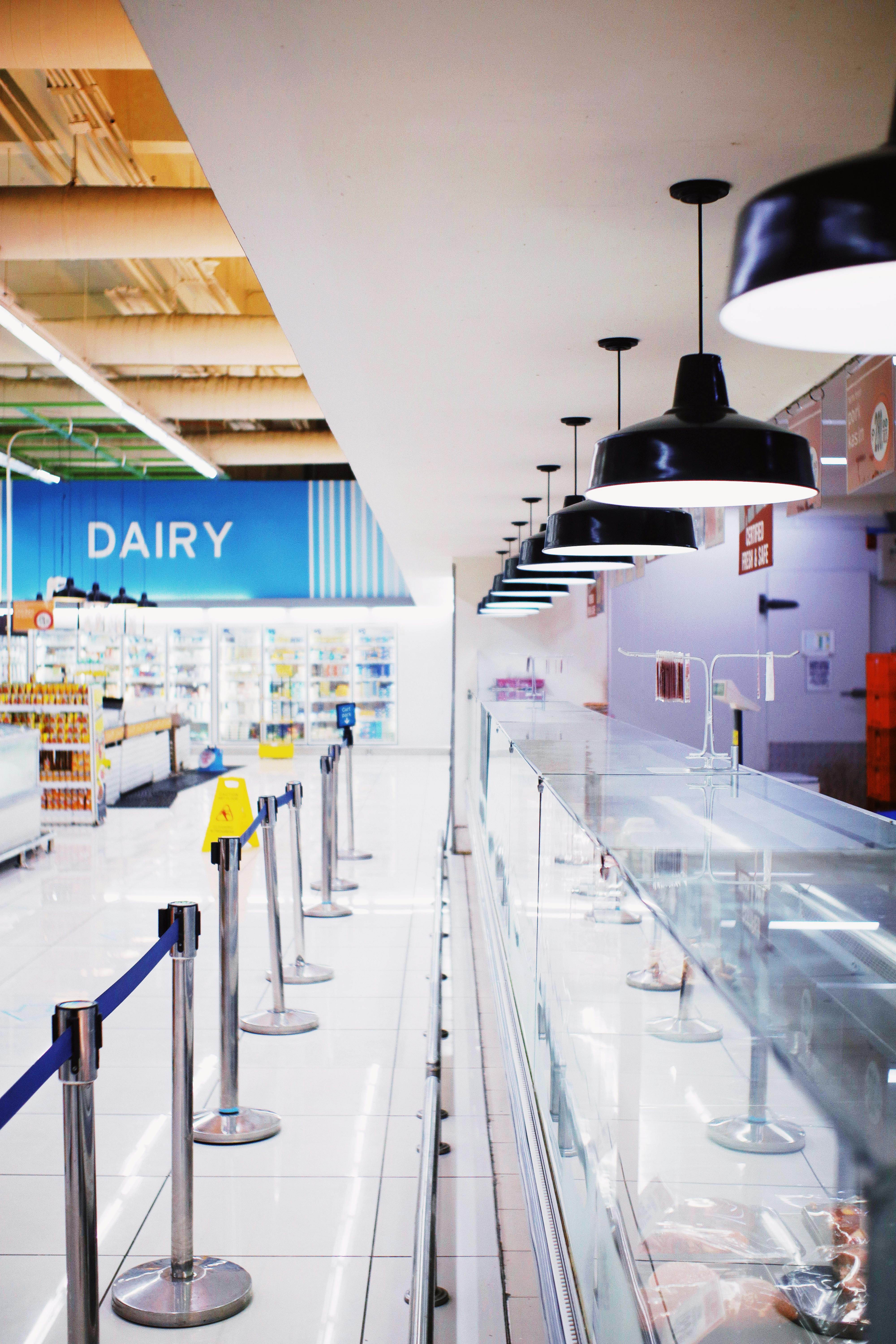 glass counter with food in supermarket