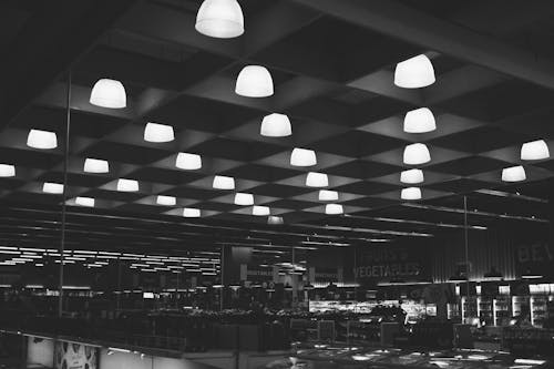 Free Bright lamps hanging in large supermarket Stock Photo