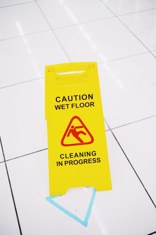 Yellow warning sign placed on floor