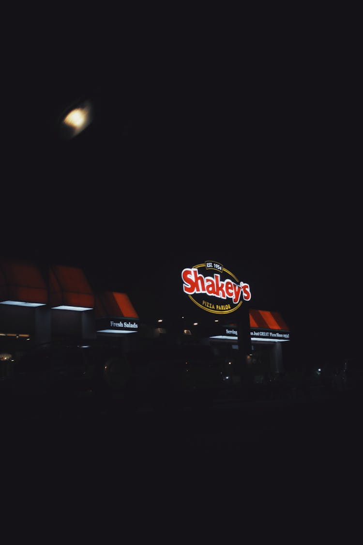 Exterior Of Restaurant With Bright Illumination In Night Time