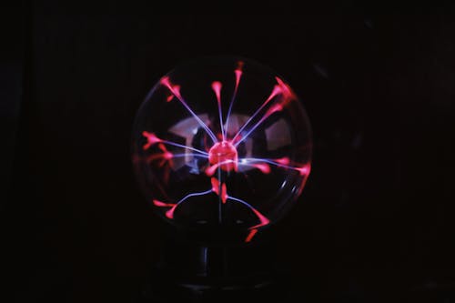 Plasma ball with bright electric light in darkness