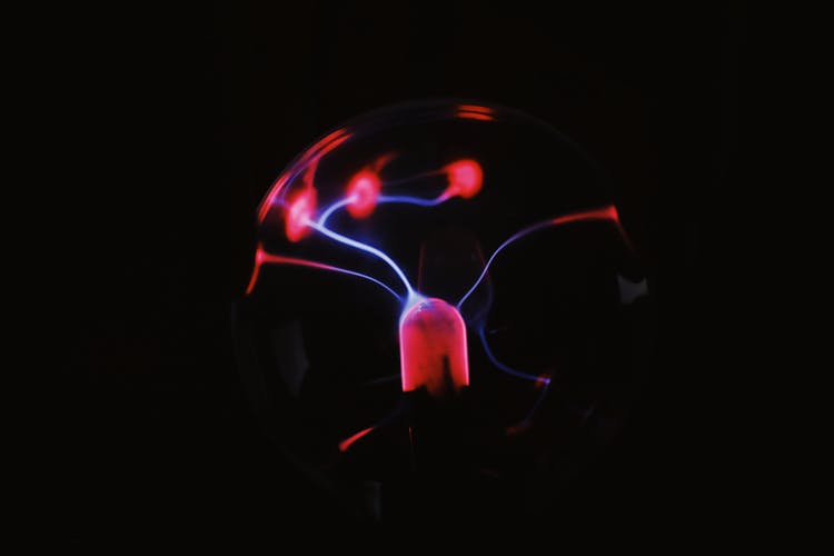 Bright Plasma Ball With Red Lights In Darkness