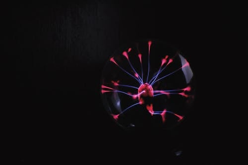 Shiny plasma ball against dark background