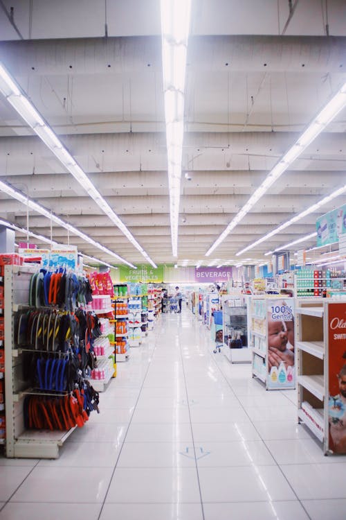 Free Interior of light spacious hallway among shelves with assorted products in contemporary supermarket Stock Photo