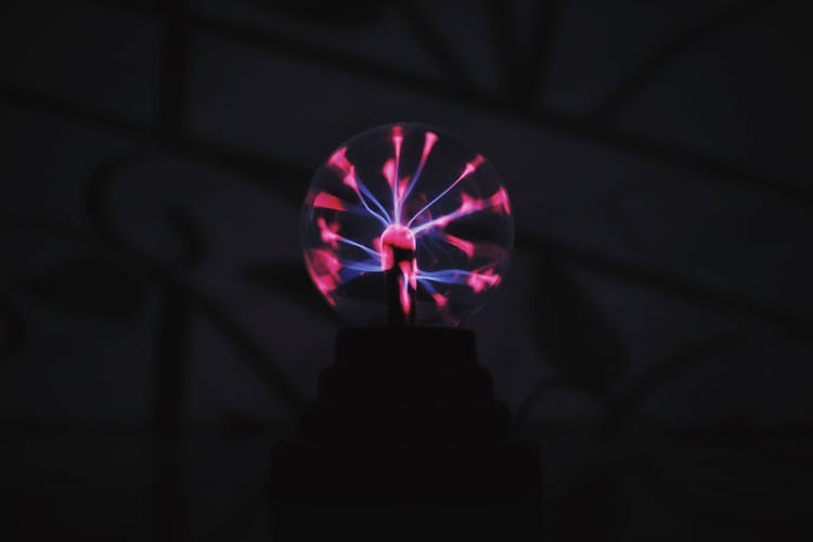 Round Plasma Ball With Bright Light In Dark Room