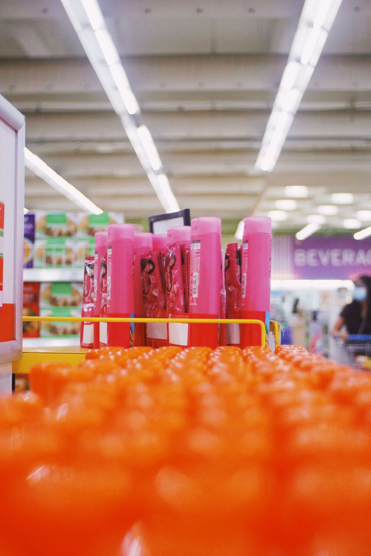 Rows of colorful shampoo bottles filling a store shelf