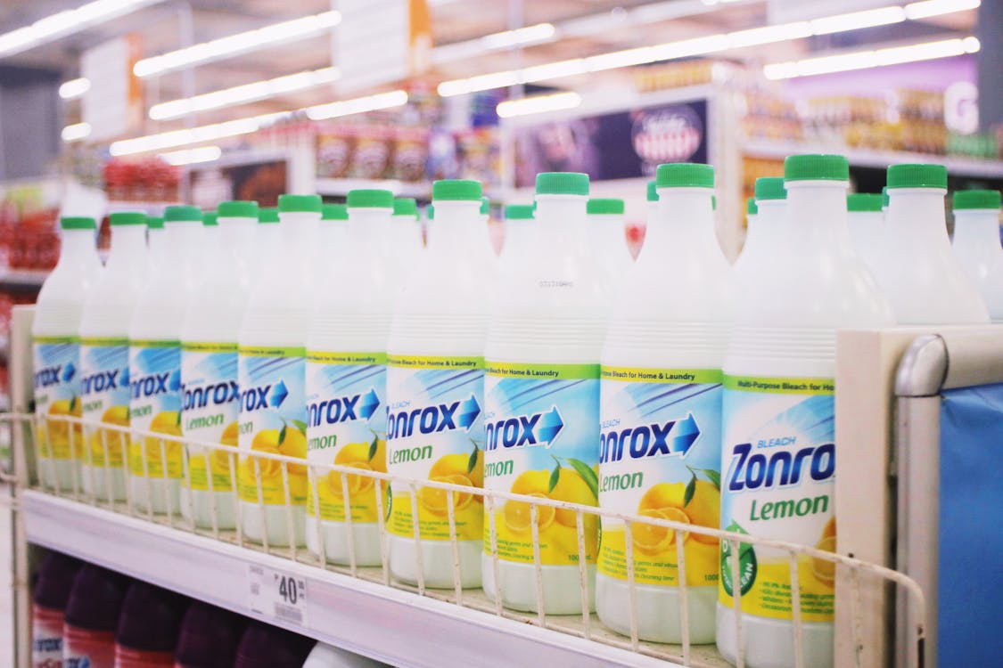 Free Rows of plastic bottles of bleach with smell of lemon placed on shelves in supermarket Stock Photo