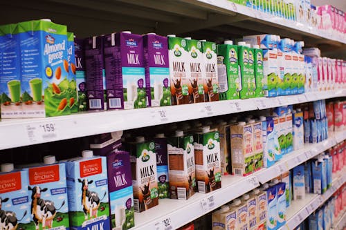 Free Shelves with various milk boxes Stock Photo