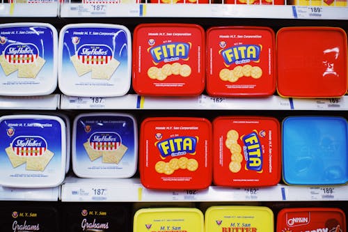 Containers with tasty cookies in supermarket