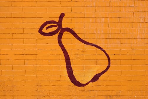 Photo of a Yellow Brick Wall with a Pear Design