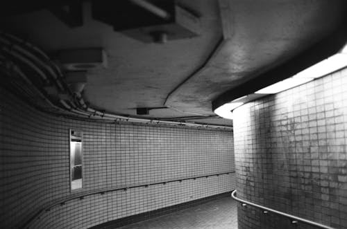Monochrome Photograph of a Tunnel with Tiles