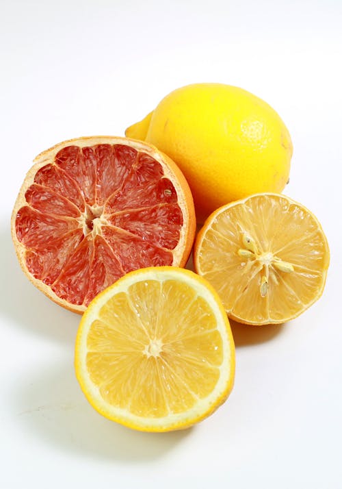 Close-Up Shot of Sliced Lemons on White Surface