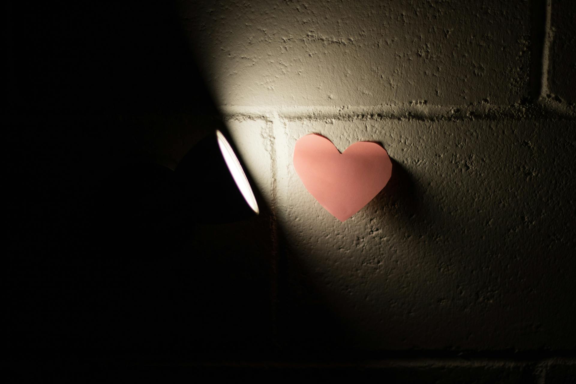 A Heart Shaped Paper on a Concrete Wall