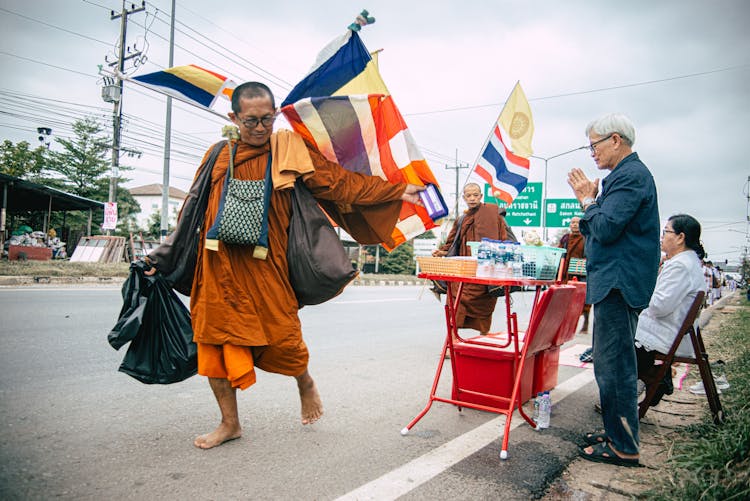 Monk Carrying Bags