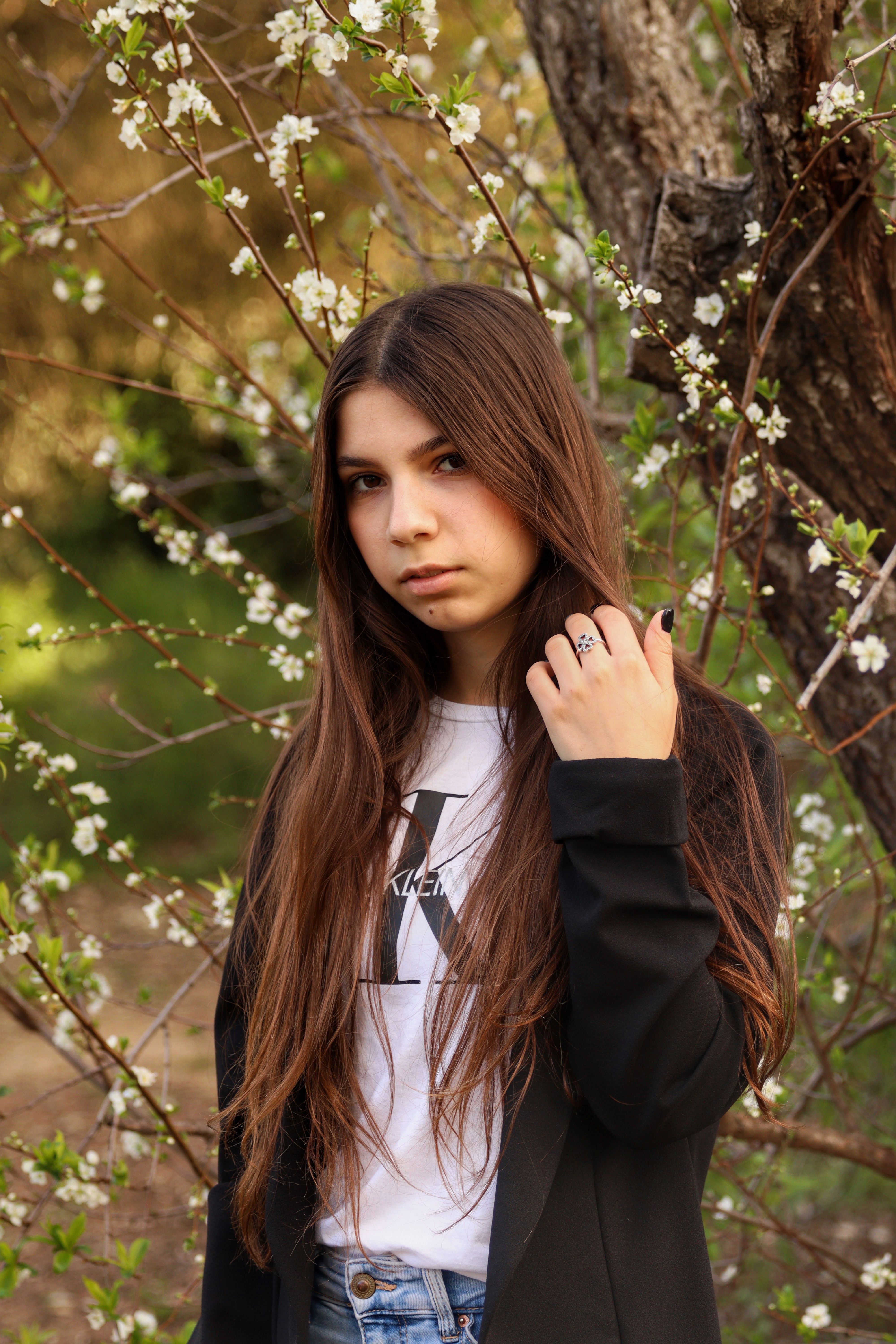 Woman in Black Jacket Standing Near Brown Tree · Free Stock Photo