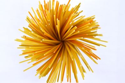 Bundle of uncooked spaghetti seen end-on against white — photo by Miguel A. Padrinan on Pexels