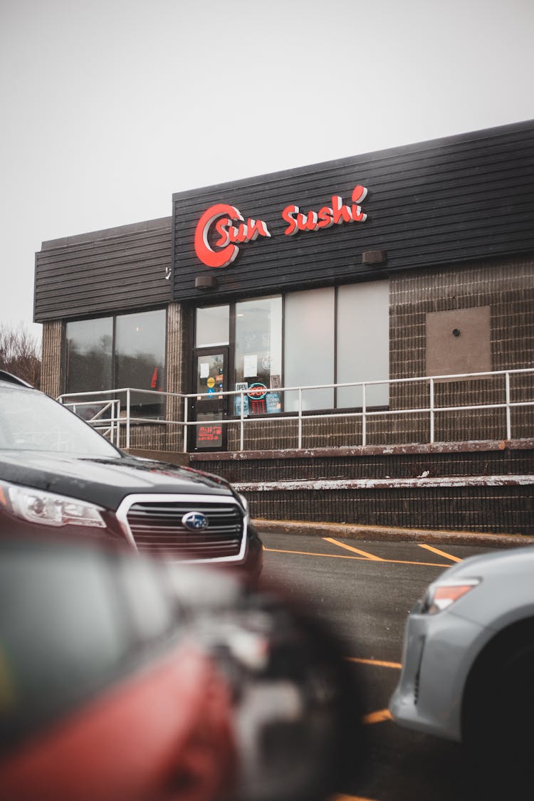 Parked Cars Against Restaurant With Asian Food