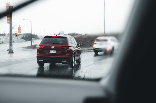 Red SUV Driving on the Wet Road