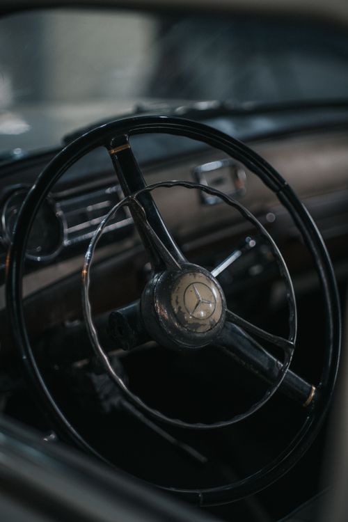Free Detailed view of a classic Mercedes-Benz steering wheel highlighting vintage design. Stock Photo