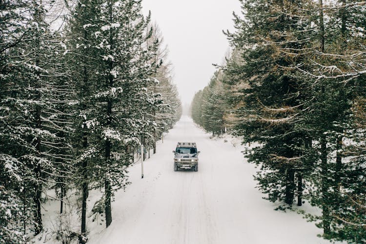 SUV Driving On Snow Covered Road