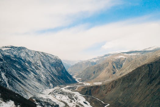 Breathtaking aerial view of rugged mountains and river in Altai, Russia.