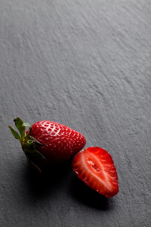 Close-Up Photo of Red Strawberries on a Gray Surface