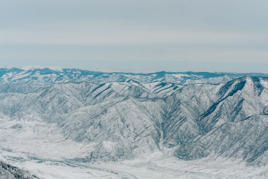 A breathtaking aerial shot of snow-covered mountains in Russia during winter.