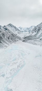 Breathtaking aerial view of the snow-covered Altai Mountains in Russia, showcasing pristine winter beauty.