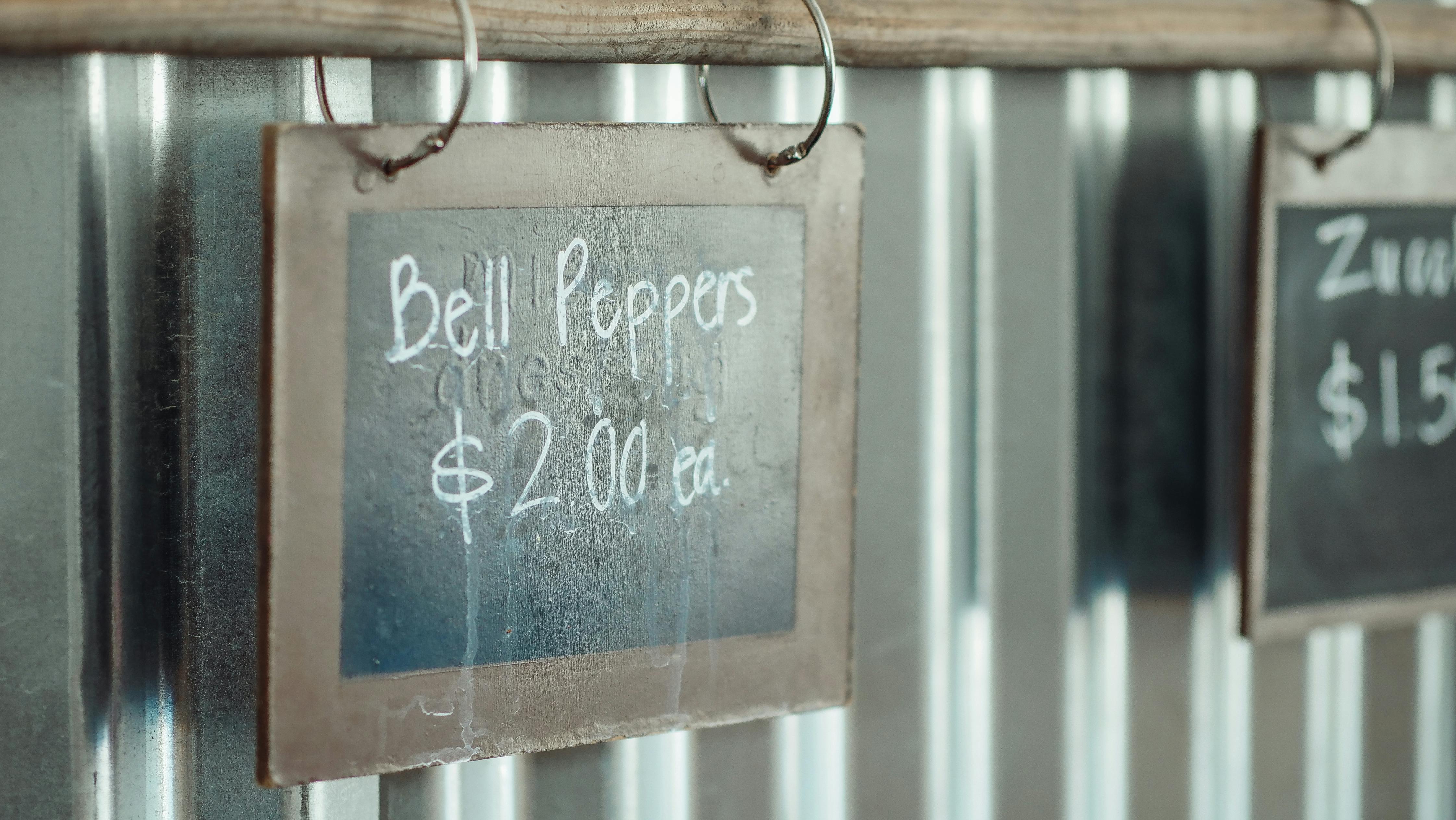 a menu board hanging on a wooden pole