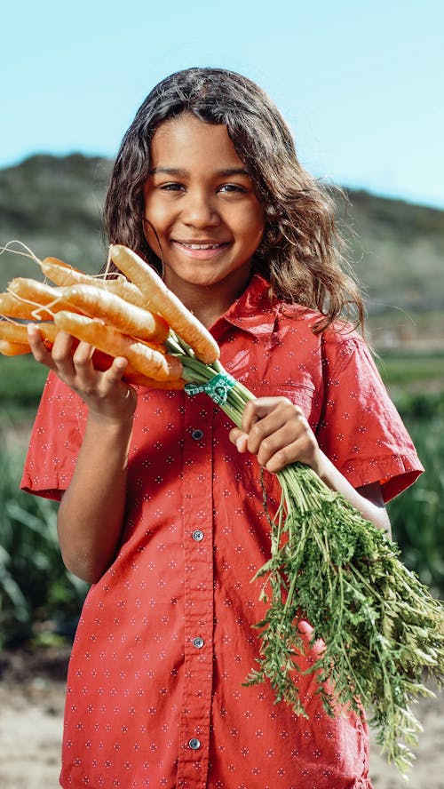 Boy Holding Carrots