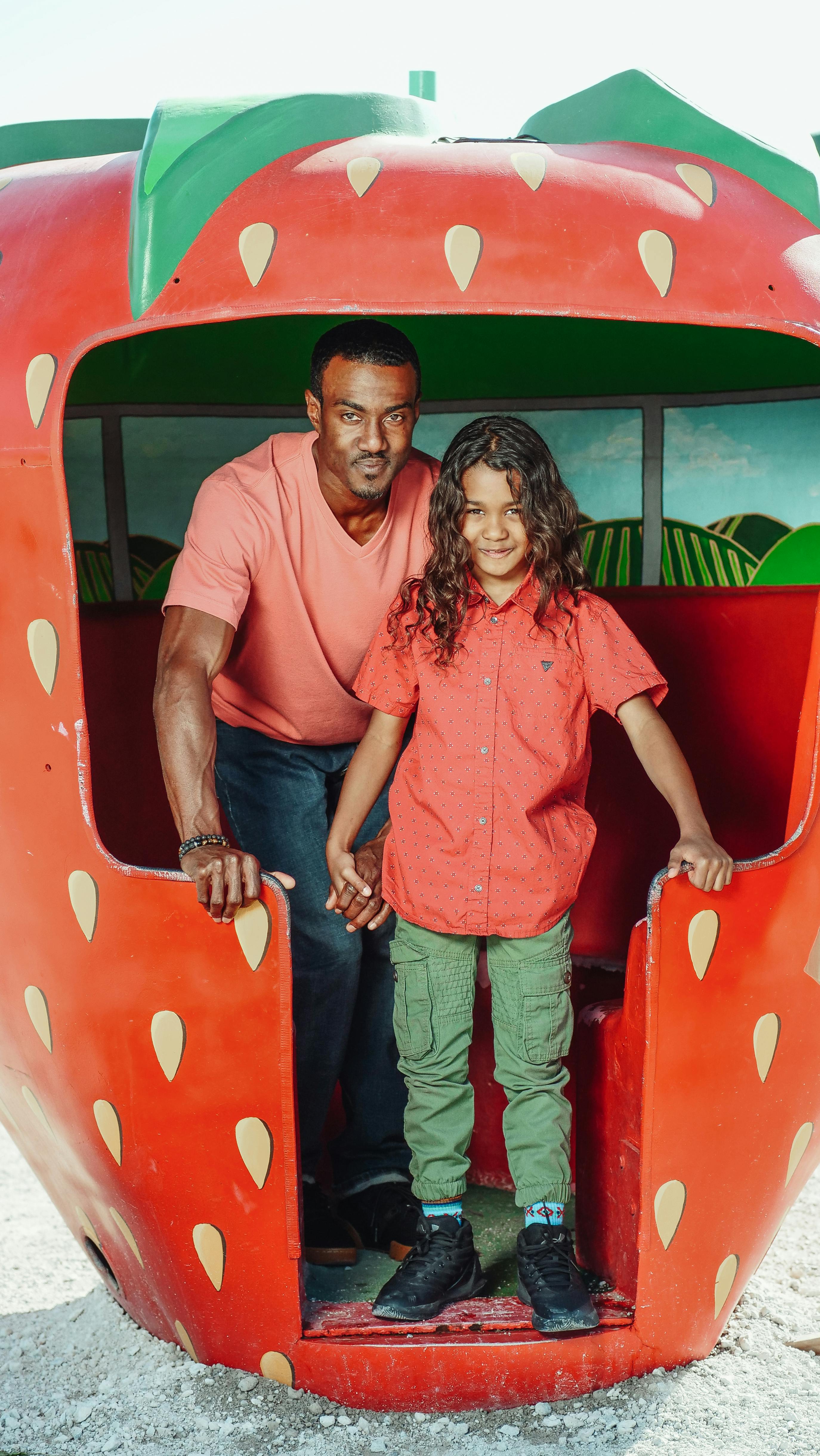 man in red polo shirt standing beside woman in red shirt