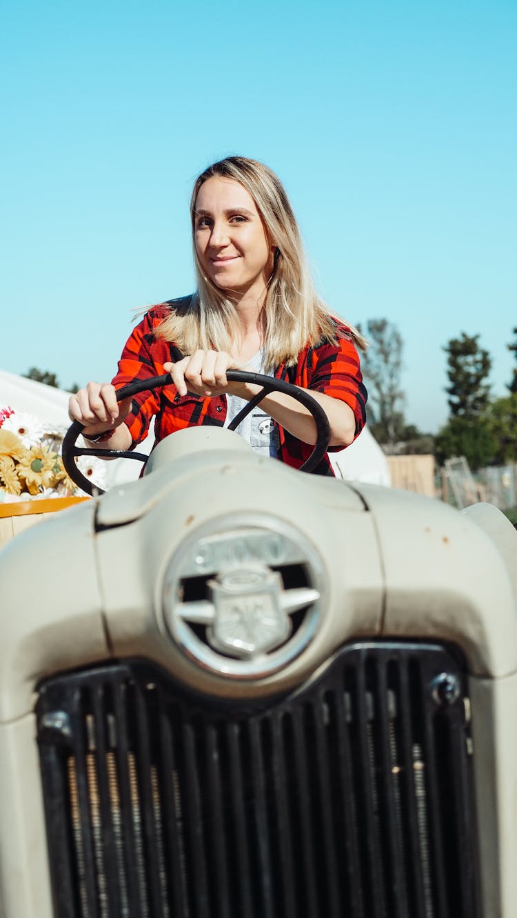 A Woman Driving A Tractor