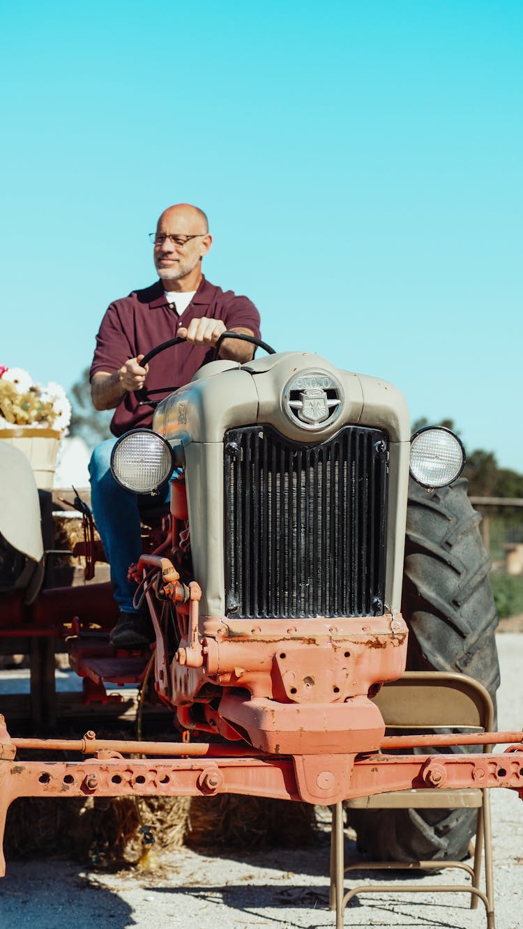 A Man Driving A Tractor