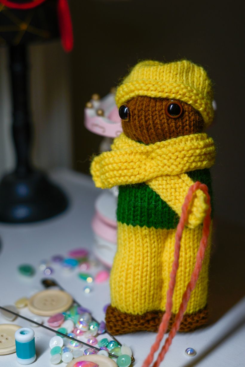 Handmade knitted doll surrounded by sewing supplies — photo by Alexandra Edin on Pexels