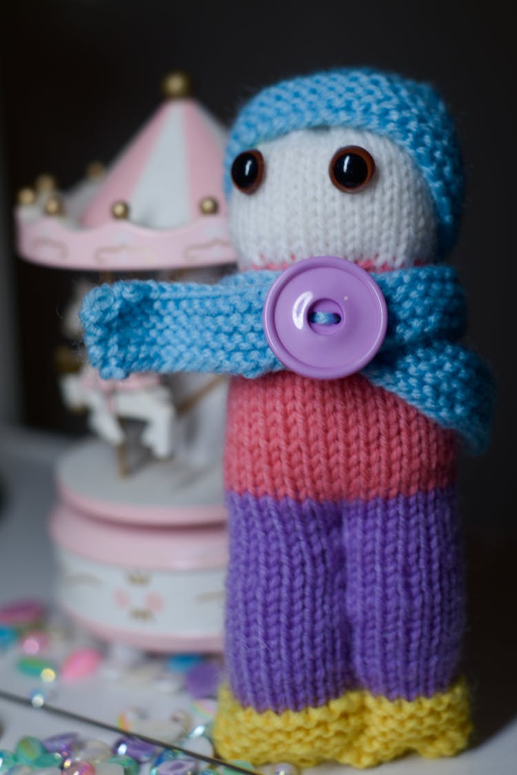 A Close-Up Shot Of A Knitted Doll