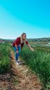 Woman in Red and Blue Plaid Shirt and Blue Denim Jeans Standing on Dirt Road during