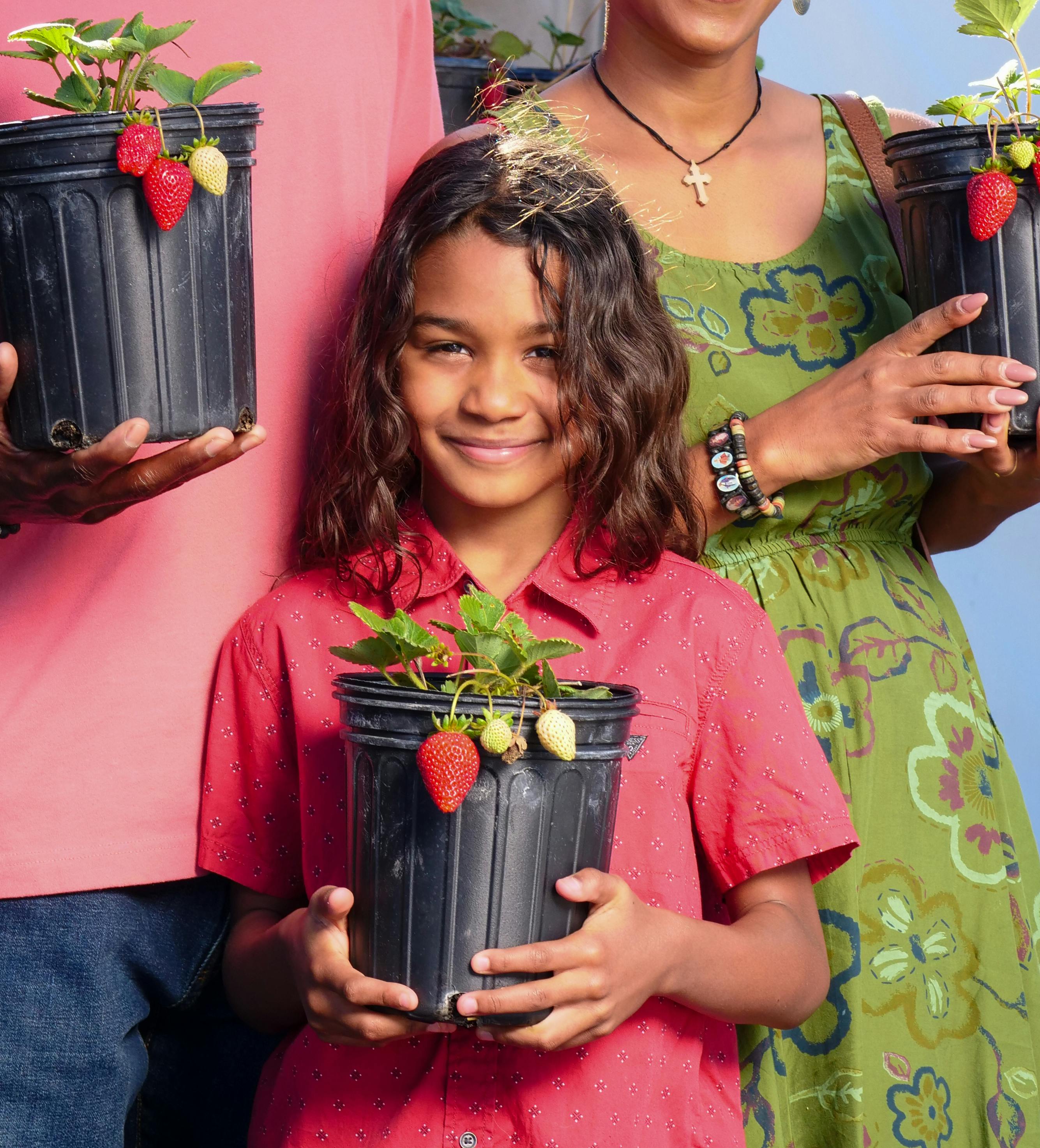 woman in red shirt holding bouquet of flowers