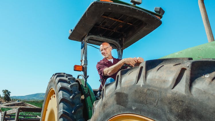 Bald Man Driving A Tractor Truck 