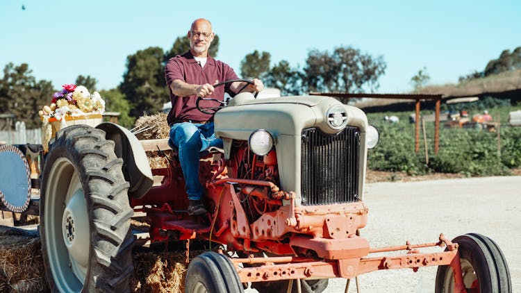 Man In The Farm Driving A Tractor Truck