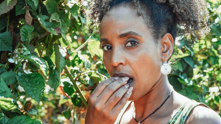 Woman Eating Newly Harvest Fruit 