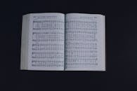 Opened book with music notes against dark background
