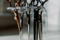 Steel stylish professional barber scissors in plastic stand