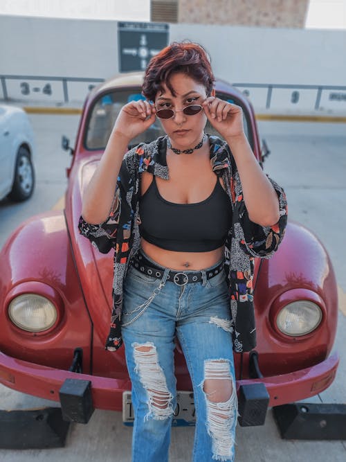 A Short-Haired Woman in Streetwear with Sunglasses Looking at Camera 
