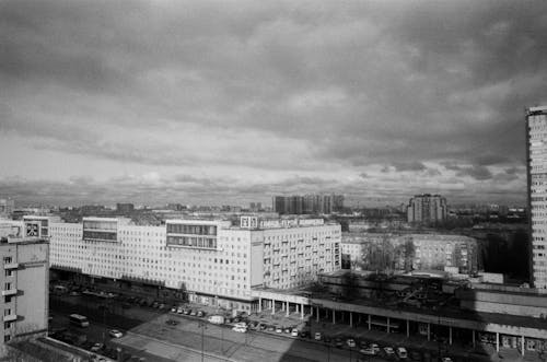 Grayscale Photo of City Buildings under the Sky