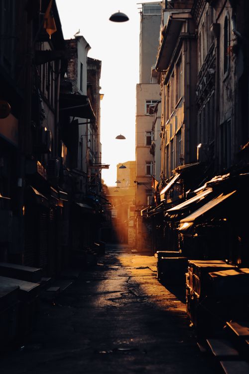 Free A beautifully lit narrow alley in Istanbul, Turkey, showcasing urban architecture at sunset. Stock Photo